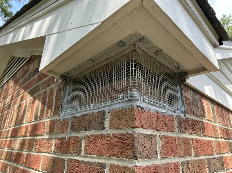 Gap in the Soffit Sealed With Steel Mesh | Music City Wildlife A freshly installed galvanized steel hardware-cloth screen and sealant closing a gap where the roof meets the soffit on a Tennessee brick home, clean workmanship, bright daylight.